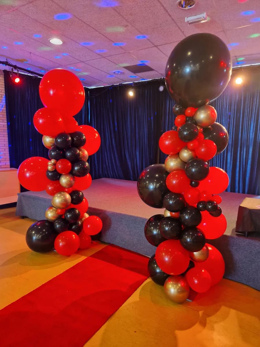 Ballonpilaren naast podium voor openingsevenement door Zavi Events